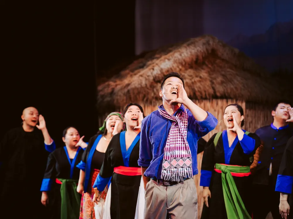 Villagers in Hmong dress look skyward during the New Year chant.