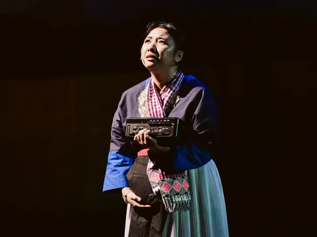 Jou holds a cassette player close, listening to the last message Lee Lue left her.